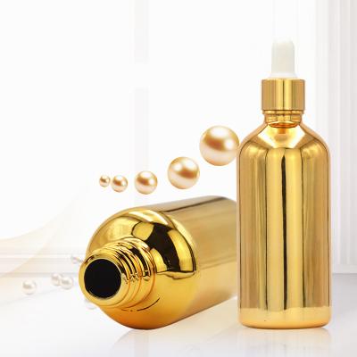 China Personal Care Plated Gold Oil Bottle 20ml 30ml 50ml Gold Bottle Small Essential Glass Cosmetics Bottle for sale