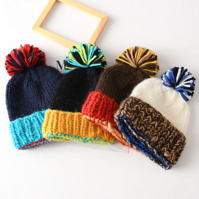 China JOINT Large Color Hairball Ladies Hearing Protection Contrast Thick Warm Knitted Hat Custom Designer Beanie Hat for sale