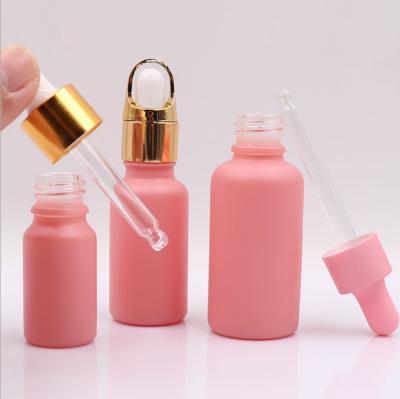 China Best Personal Care Cosmetic Packaging 10ml 20ml 30ml Frosted Pink Dropper Bottles Oil Cosmetic Bottle for sale