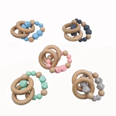 China Soft Silicone Nursing Toy Baby Silicone Teether Handmade Bead Teething Wooden Ring Bead With Bracelet for sale