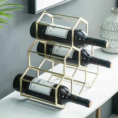 China Sustainable Honeycomb Decoration Wine Rack Table Top Gold Wine Rack for sale