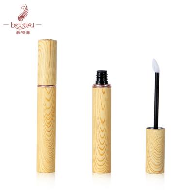 China Cosmetic jumbo size 8ml empty wooden grain decorated metal liquid lipstick/lip plumper bottle/tube/container with heart shaped brush for sale