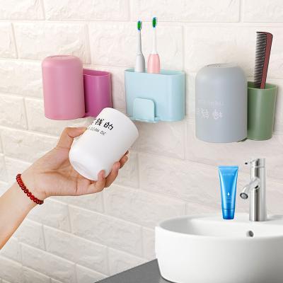 China Viable plastic punchless toothpaste washcup holder bathroom accessories storage retainer toothbrush holder for sale