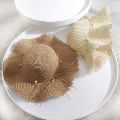 China Straw Hat Female Summer Eco-friendly Wave Along Pearl Bow Knot Big Brim Travel Beach Sunscreen Hat Korean Wholesale for sale