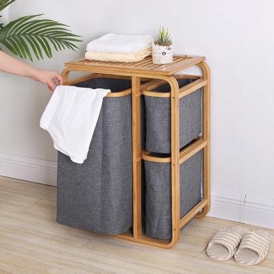 China 3 Compartment Cabinet Clothing Organizer Lacquer Finish Dirty Clothes Basket Shelf Storage Sorter for Home Organization for sale