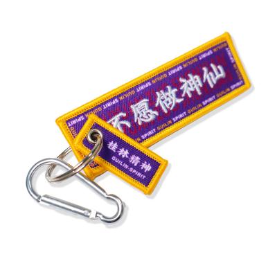 China Fashionable Custom Embroidered Patch Key Flag Woven Fabric Embroidery Key Chain With Buckle for sale