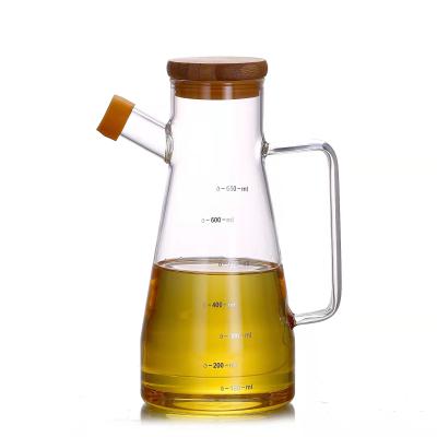 China Sustainable High Borosilicate Glass Oil Dispenser Heat Resistant Bottle With Lid And Bamboo Handle For Kitchen for sale