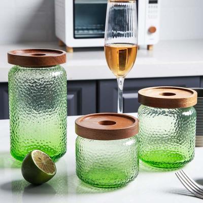 China Sustainable hot selling solid colored green hammered glass storage jar with airtight acacia wood lid for home kitchen for sale