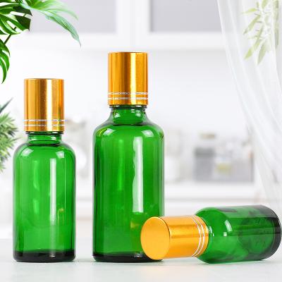 China Cosmetic green glass bottle for oil glass bottle for sale