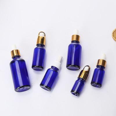 China 5ml 10ml 15ml 20ml 30ml 50ml 100ml e cosmetic blue glass liquid oil bottle for sale