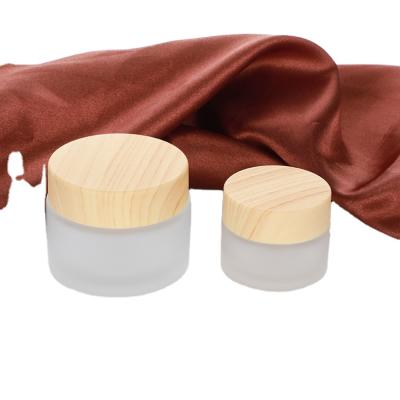 China Hot Selling Face Cream Glass Jar Cosmetic Container 5ml 15ml 30ml 50ml 100ml Frosted Clear Glass Jar With Bamboo Wooden Lid for sale