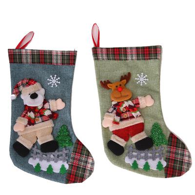 China New Christmas Tartan Non-Woven Tartan Decorations Three-Dimensional Sand Cotton Plush Figures Dancing Santa Stockings Gift Bags for sale