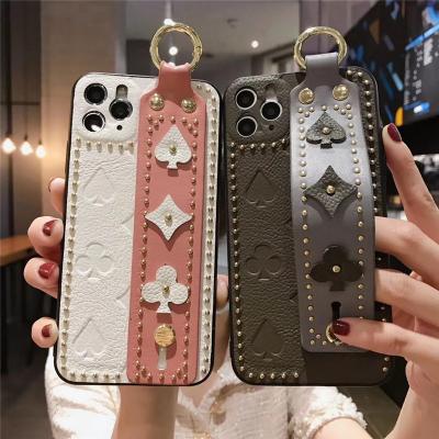 China Lady Style Rivet Wrist Shockproof Luxury Stand Fashion Genuine Leather Phone Back Case For iPhone 13 7 8 X XS XR XS Max for sale