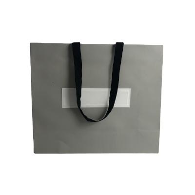 China Recycled Materials Medium Size Luxury Paper Shopping Bag With Own Logo Printed Paper Bags With Handles for sale