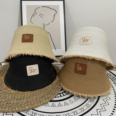 China Image Hand - 2021 Summer Hat Designer Straw Hats Women New Woven Bucket Hat Beach Tie Sun Cap for sale