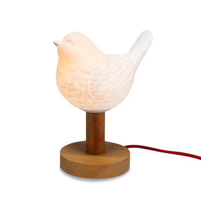 China Wooden Base Modern White Cute Animal Decorative Led Unique Lamp Porcelain Lights Bird Shape Mini Led Table Lamp for sale