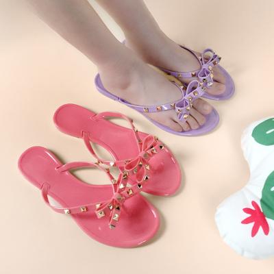 China Fashion Rivet Bow PVC Waterproof Wholesale Hot Selling Slippers Customized Jelly Flip Flops Women for sale