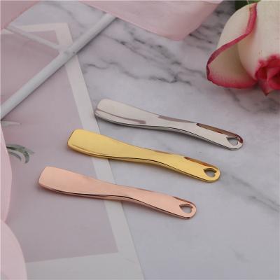 China Zinc Alloy Cosmetic Eye Cream Gold Spatula Design OEM Sticker Face Lift Mini Makeup Spoon Mixing Massage for sale