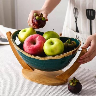 China 2021 Top Design Viable Custom Design Gold Popular Grade Gold Ceramic Fruit Bowl With Wooden Paddle for sale