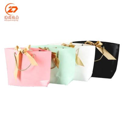 China Recyclable shopping bag wholesale and custom printed paper bags with ribbon for sale