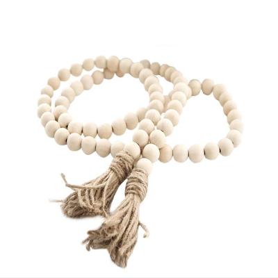 China Eco-friendly Hot Sale Natural Unfinished Wooden Bead Garland With Tassels Country Rustic Decor for sale