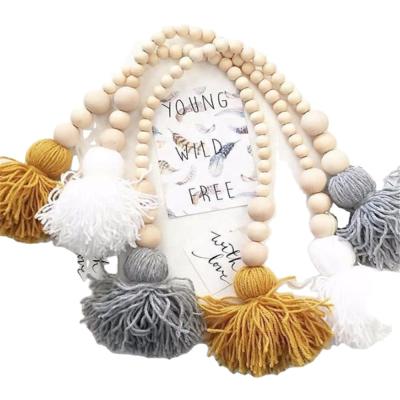 China Perfect Gifts for Graduates Wooden Bead Garland with Tassel Decorations Rustic Wooden Beaded Wall Hanging Home Decor for sale