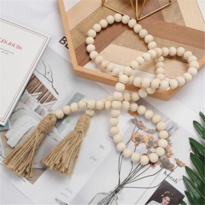 China Perfect Gifts for Graduates Wooden Beads Garland with Tassels Farmhouse Rustic Natural Wooden Bead String Wall Hanging for sale