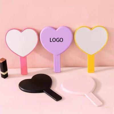 China Low MOQ Double Sided Customized Colorful Plastic Heart Shape Portable Pocket Beauty Tools Logo Handle Handheld Makeup Mirror for sale