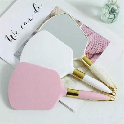 China Double Sided Handheld Makeup Mirror Vanity Mirror SPA Salon Makeup Vanity With Handle Cosmetic Mirror For Women for sale