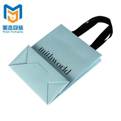 China Luxury And Elegant Recyclable Clean Design Paper Sack Gift Paper Bag With Ribbon Handle for sale