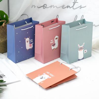 China Retail Recyclable Cute White Back Bag Birthday Gift Garment Bag Eco-Friendly Cartoon Portable Paper Bag Stain Cardboard Paper Bag for sale