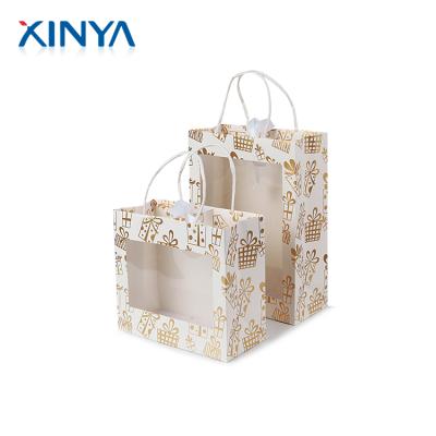 China Recyclable XINYA Customized Printed Beautiful Bolsas De Regalo Gift Paper Bags With Ribbon for sale