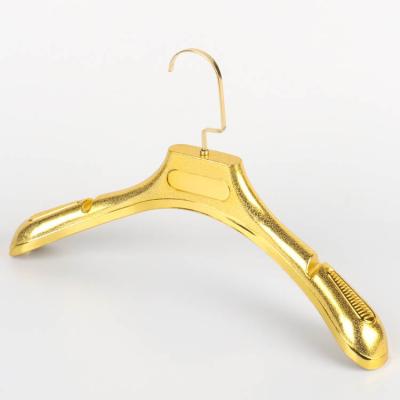 China Plastic Shirt Hangers Gold Color Women Clothes Hanger Cheap Durable Storage Rack For Shop for sale