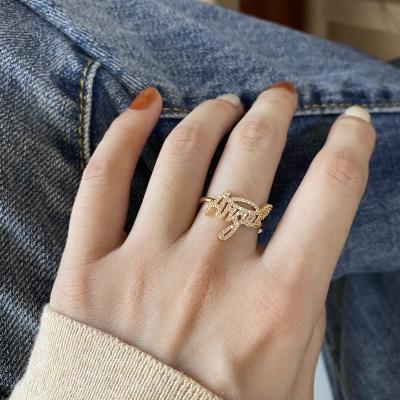 China Eco Friendly Fashionable Resizable Adjustable Open 14K Gold Plated Iced Gold Angle Letter Dish Pave Zircon Ring for sale