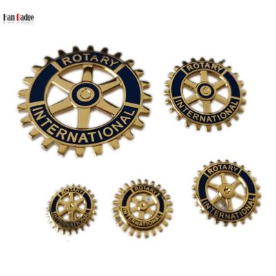 China Custom Europe Rotary International Club Pin Stamping Brass Hard Enamel Badge with 6 Cut Outs 24K Gold Plating for sale