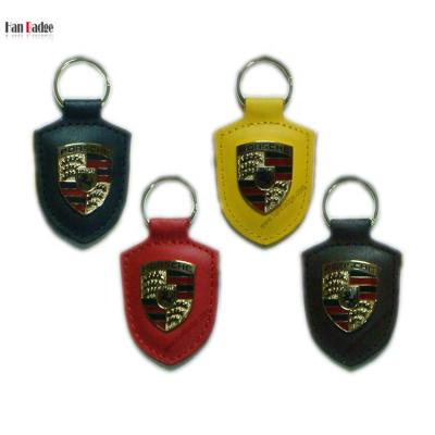 China Leather & Custom Genuine Leather Enamel Metal Key Ring Die Struck Brass Soft Keychains for sale