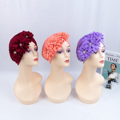 China Fashion Hot Selling Hijabs Hats Popular Solid Color Flower Women Muslim Turban Cap for sale