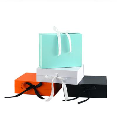 China Handmade Custom Logo Luxury Hard Cardboard Folding Gift Box With Ribbon Closure for sale