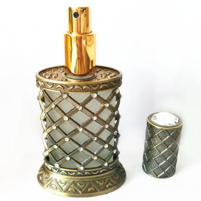 China Luxury Style 40ml Acrylic Perfume Bottle Polished Bronze Decorated Luxury Glass Perfume Bottle for sale