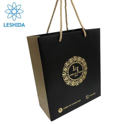 China Fashion Gold Foil Recyclable Customized Black Paper Bag With Logo Promotional Black Paper Shopping Bags for sale