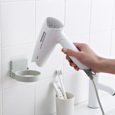 China Wall Mounted Simple Suction Household Hair Dryer Rack Popular Mutifunction Holder Cup Storage Free Punch Plastic Holder for sale