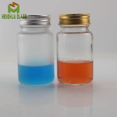 China 75ml 75cl clear round glass capsule pill bottle frosted capsule glass bottle herbal bottle with aluminum cap for sale