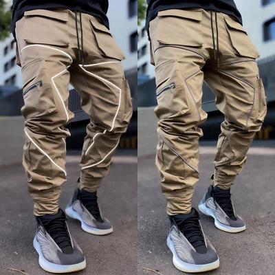 China Anti-wrinkle custom men's spring autumn sports new casual plus size cargo sweatpants solid color multi-pocket track reflective striped pants for sale