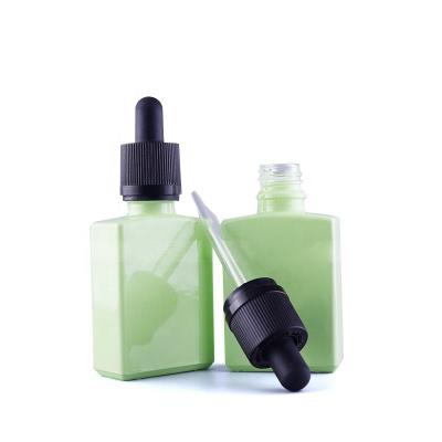 China Personal care factory direct sales 30ml smoke oil bottle glass bottle flat square green empty wine bottle for sale