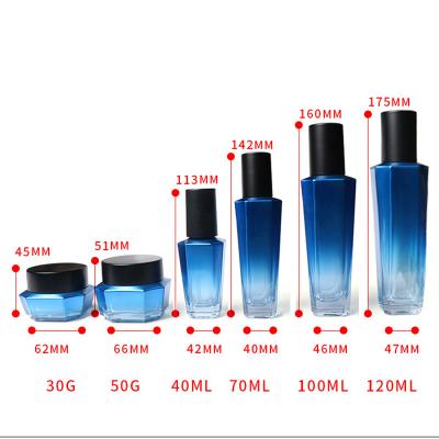 China Custom Hexagonal Gradient Blue Glass Cosmetic Bottle Set Cosmetic 100ml Lotion Glass Bottle With Black Screw Cap for sale