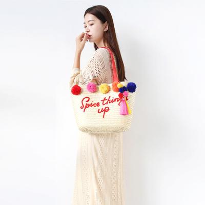 China Eco Friendly Girls Women Custom Logo Summer Beach Straw Woven Shoulder Bag Tote Bag Portable With Pom Pom for sale