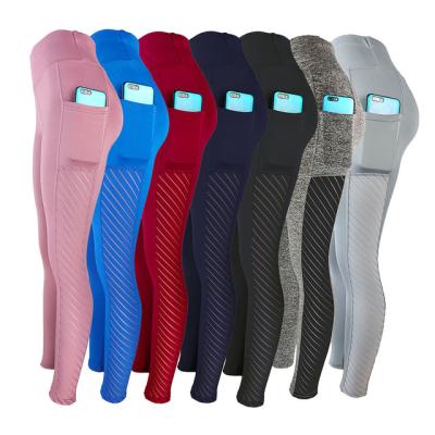 China Breathable Sports Wear Women Fitness Wear Workout Gaiters With Pockets Butt Lift Compression Tights Yoga Pants for sale