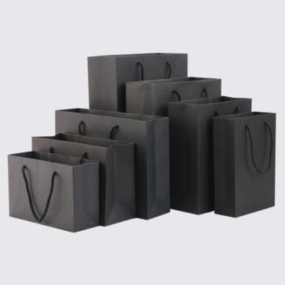 China Handmade Wholesale Custom Black White Craft Gift Kraft Shopping Paper Bags With Handle for sale