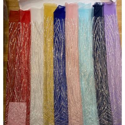 China Handmade Swiss DELACE voile colorful machine beaded luxury lace fabric high quality wave line shimmer adornable fabric for dress for sale