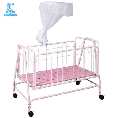 China Durable 857 Swinging Baby Crib Iron Baby Bed With Wheels for sale